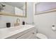 Stylish bathroom featuring a vanity with gold hardware and decorative gold trimmed mirror at 7910 Hooker St, Westminster, CO 80030