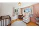 Bright Bedroom with wood floors, neutral walls, and a round rug for a cozy touch at 7910 Hooker St, Westminster, CO 80030