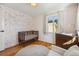 Charming Bedroom with wood floors, crib, changing table and patterned wallpaper at 7910 Hooker St, Westminster, CO 80030