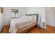 Cozy bedroom with hardwood floors, a plush bed, and a minimalist nightstand at 7910 Hooker St, Westminster, CO 80030