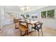 Bright dining room featuring a stylish light fixture, tile flooring, and a spacious wooden table with bench at 7910 Hooker St, Westminster, CO 80030