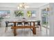 Elegant dining room with stylish lighting, a large table, and access to the backyard at 7910 Hooker St, Westminster, CO 80030