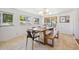 Dining area featuring a wooden table and bench, modern light fixture, and sliding doors to the outside at 7910 Hooker St, Westminster, CO 80030