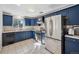 Cozy kitchen with stainless steel appliances, bright countertops, and beautiful blue cabinets at 7910 Hooker St, Westminster, CO 80030
