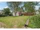 Spacious backyard with a storage shed, trees, and a wooden fence, perfect for outdoor activities and relaxation at 1340 Iola St, Aurora, CO 80010