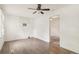 Bright room with wood floor, neutral walls, air conditioner, and doorway to carpeted room at 1340 Iola St, Aurora, CO 80010