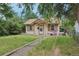 Charming single-story home with a quaint front porch and overgrown lawn at 1340 Iola St, Aurora, CO 80010