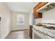 Bright kitchen with wooden floors, white appliances, and window view at 1340 Iola St, Aurora, CO 80010