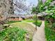 A lush backyard featuring a well-maintained lawn, a quaint brick storage shed, and garden at 767 S York St, Denver, CO 80209