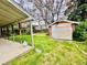 View of the yard with shed and the covered patio and yard beyond at 767 S York St, Denver, CO 80209