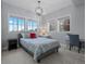 Bright bedroom featuring large windows, a decorative light fixture and neutral paint at 10597 Soulmark Way, Highlands Ranch, CO 80126