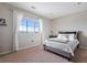 Bright bedroom featuring scenic views, comfortable bedding, and neutral decor at 10597 Soulmark Way, Highlands Ranch, CO 80126