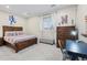 Cozy bedroom with a wooden bed, ample storage, and a dedicated study area at 10597 Soulmark Way, Highlands Ranch, CO 80126