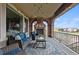 Relaxing covered patio with a stone fireplace, comfortable seating, and scenic views at 10597 Soulmark Way, Highlands Ranch, CO 80126