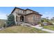 Inviting stone-accented front entrance with arched windows and covered entryway at 10597 Soulmark Way, Highlands Ranch, CO 80126