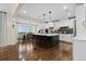 Contemporary kitchen with large island, stainless steel appliances, and seamless flow into the dining room at 10597 Soulmark Way, Highlands Ranch, CO 80126