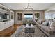 Bright living room featuring a cozy seating arrangement, built-in shelving, and picturesque mountain views at 10597 Soulmark Way, Highlands Ranch, CO 80126
