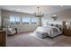 Spacious main bedroom featuring mountain views, a modern chandelier, and comfortable seating at 10597 Soulmark Way, Highlands Ranch, CO 80126