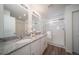 Bright bathroom featuring a double vanity with granite counters and a glass-enclosed shower at 13545 E 103Rd Ave, Commerce City, CO 80022