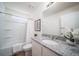 Bright bathroom features granite counters, a bathtub with shower, and wood-look flooring at 13545 E 103Rd Ave, Commerce City, CO 80022