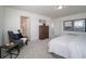A cozy carpeted bedroom is furnished with a comfortable armchair and a modern dresser at 13545 E 103Rd Ave, Commerce City, CO 80022