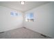 Neutral bedroom with plush carpet, neutral walls, and double windows with neighborhood views at 13545 E 103Rd Ave, Commerce City, CO 80022