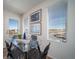 Bright dining area with a glass-top table, wicker chairs, and a large window with neighborhood views at 13545 E 103Rd Ave, Commerce City, CO 80022