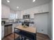 Contemporary kitchen with white cabinets, stainless steel appliances, and granite countertops at 13545 E 103Rd Ave, Commerce City, CO 80022