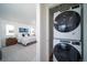 A discreet stackable Whirlpool washer and dryer conveniently located near the bedroom at 13545 E 103Rd Ave, Commerce City, CO 80022