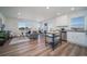Spacious living space connecting the kitchen, dining, and living areas with ample natural light at 13545 E 103Rd Ave, Commerce City, CO 80022