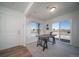 Sunlit office featuring a wooden desk, a large window, and sliding glass door access at 13545 E 103Rd Ave, Commerce City, CO 80022
