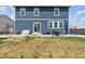 This home has a yard with a patio that features outdoor seating and a blue-sided house with a shingled roof at 7498 E 157Th Pl, Thornton, CO 80602