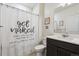Bathroom with a decorative shower curtain, toilet, and vanity with a sink at 7498 E 157Th Pl, Thornton, CO 80602