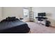 Modern bedroom with a bed, desk, and large window at 7498 E 157Th Pl, Thornton, CO 80602