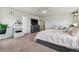 A large bedroom featuring carpet, a large bed, and a TV with a dresser underneath it and light-colored walls at 7498 E 157Th Pl, Thornton, CO 80602
