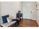 Inviting entryway featuring hardwood floors, a bench seat, and a charming decor at 7498 E 157Th Pl, Thornton, CO 80602