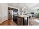Stylish kitchen with a large island, stainless steel appliances, and dark cabinets at 7498 E 157Th Pl, Thornton, CO 80602