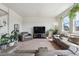 Bright living room with comfortable seating, large windows, and a neutral color palette at 7498 E 157Th Pl, Thornton, CO 80602
