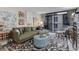 Comfortable living room featuring an L-shaped sofa, patterned rug and eclectic decor at 2 Adams St # 809, Denver, CO 80206