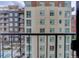 A balcony view of an apartment building featuring light brick and a dark brick building with balconies at 2 Adams St # 809, Denver, CO 80206