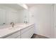 Bathroom with double sinks and white cabinets offering a clean and modern aesthetic at 1280 S Algonquian St, Aurora, CO 80018