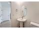 Powder room with pedestal sink and sleek fixtures creating a modern design at 1280 S Algonquian St, Aurora, CO 80018