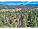 Aerial view of the property showcasing its secluded location in a lush, wooded area at 28669 Mountain View Rd, Conifer, CO 80433