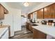 A view of the kitchen features updated countertops, wood cabinets, and stainless appliances at 28669 Mountain View Rd, Conifer, CO 80433