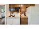 Cozy kitchen with ample cabinetry and white appliances with an oven, cooktop and microwave at 28669 Mountain View Rd, Conifer, CO 80433