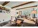 Cozy living room with exposed beams, picture window and a comfortable sofa at 28669 Mountain View Rd, Conifer, CO 80433