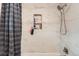 Shower area features marble-look tile and a convenient shelf at 28669 Mountain View Rd, Conifer, CO 80433