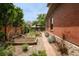 Backyard featuring raised garden beds, a brick pathway, and beautiful landscaping at 2845 Quitman St, Denver, CO 80212