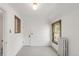 Spacious bedroom with a window, white walls, and classic radiator at 2845 Quitman St, Denver, CO 80212
