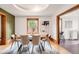 Open dining room with wood floors, a window view, a modern light fixture, and art at 2845 Quitman St, Denver, CO 80212